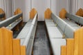Rows of grey Pews inside of a Church