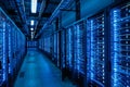 Rows of high-performance servers fill a modern data center, lit with a blue hue, Royalty Free Stock Photo