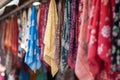 rows of hijabs hanging from a market stall