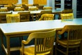 Rows of institutional chairs and tables in learning environment Royalty Free Stock Photo