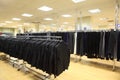 Rows of jackets and men trousers in shop Royalty Free Stock Photo