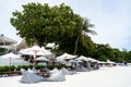 Rows of lounge chairs and sun umbrellas on the white sand beach Royalty Free Stock Photo