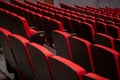Rows of luxurious, expensive, red chairs of classical design in the auditorium of classical academic theatre Royalty Free Stock Photo