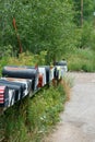 Rows of Mail Boxes sits becide a Mountian Pass Road Royalty Free Stock Photo