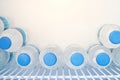 Rows of many transparent plastic bottles with drinking water supply in white refrigerator. Mineral water stack storage in fridge Royalty Free Stock Photo