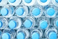 Rows of many transparent plastic bottles with drinking water supply in white refrigerator. Mineral water stack storage in fridge Royalty Free Stock Photo