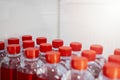 Rows of many transparent plastic bottles with drinking water supply in white refrigerator. Royalty Free Stock Photo