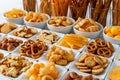 Rows of many types of savory snacks in white ceramic dishes. Royalty Free Stock Photo