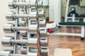 Rows of metal heavy dumbbells on stand in sport gym, physiotherapy clinic. Physical therapy center. Sports equipment for training. Royalty Free Stock Photo