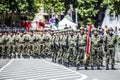 Rows of military troop marching on streets during sunny summer day Royalty Free Stock Photo