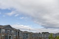 Rows of modern apartment buildings with blue sky with clouds