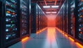 Rows of modern server racks in a data center with orange lighting. Servers have various colored lights indicating activity. Data Royalty Free Stock Photo
