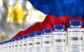 Rows of multiple Covid-19 vaccine ampules with Philippines flag in background. Mass production and inoculation concept.