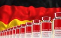 Rows of multiple Covid-19 vaccine vials with flag of Germany in background. Mass production and inoculation concept. 3d rendering Royalty Free Stock Photo
