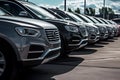 Rows of new cars parked in a dealership parking lot for sales, automotive industry