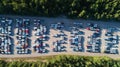 Rows of new cars in the parking lot. Aerial view of large parking lot full of cars of various colors Royalty Free Stock Photo