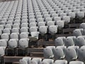 Rows of numbered empty plastic seats at an open-air amphitheater. many audience open theater seats Royalty Free Stock Photo