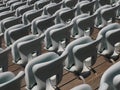 Rows of numbered empty plastic seats at an open-air amphitheater. many audience open theater seats