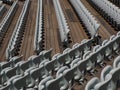 Rows of numbered empty plastic seats at an open-air amphitheater. many audience open theater seats