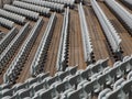 Rows of numbered empty plastic seats at an open-air amphitheater. many audience open theater seats