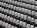 Rows of numbered empty plastic seats at an open-air amphitheater. many audience open theater seats