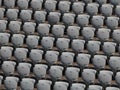 Rows of numbered empty plastic seats at an open-air amphitheater. many audience open theater seats