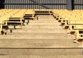 Rows of numbered old-fashioned grandstand seating divided by ais Royalty Free Stock Photo