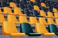 Rows of old plastic black and yellow seats at a stadium Royalty Free Stock Photo