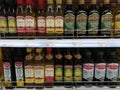 Rows of olive oil bottles on shelves in the supermarket Royalty Free Stock Photo