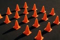 Rows of orange cones arranged on a dark surface during a training session Royalty Free Stock Photo