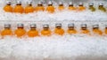 Rows of Orange Juice Bottles in Pile of Ice