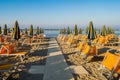 Rows of orange umbrellas and deckchairs