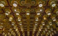 Rows of ornate, golden lanterns in a Buddhist temple