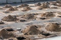 Rows of pits at a construction site. preparation of the site for the installation of piles. a pile of sand