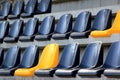 Rows of plastic black and yellow seats at a stadium Royalty Free Stock Photo