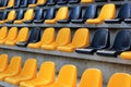 Rows of plastic black and yellow seats at a stadium Royalty Free Stock Photo