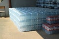 Rows of plastic water bottles stacked in bulk for sale.