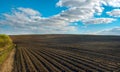 rows of plowed field in spring under a beautiful sky Royalty Free Stock Photo