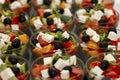 Rows of portioned Greek salads with fresh vegetables. Catering for business meetings, events and celebrations. Close-up Royalty Free Stock Photo