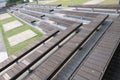 Rows of public use wooden benches arranged in amphitheatre style