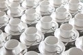 Rows of pure cup and saucer with teaspoon