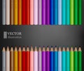 Rows of rainbow colored pencils on dark grey background.