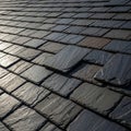 Rows of rectangular slate tiles cover a rooftop, creating a textured and uniform pattern. The dark Royalty Free Stock Photo