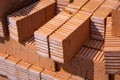Rows of red bricks. The group or the pile of new clay red orange bricks close-up on the outside warehouse or the