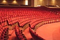 Rows of red cinema seats. View of empty theater hall. Comfort chairs in the modern theater interior Royalty Free Stock Photo