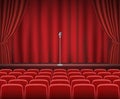 Rows of red cinema or theater seats with microphone