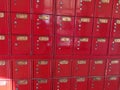 Rows of red metal post office boxes on a wall in the post office Royalty Free Stock Photo