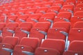 Rows of red numbered seats with armrests