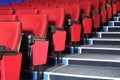 Rows of red seats and grey stairs in auditorium