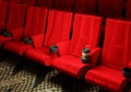 Rows of red velvet seats watching movies in the cinema with copy space banner background. Entertainment and Theater concept. 3D Royalty Free Stock Photo